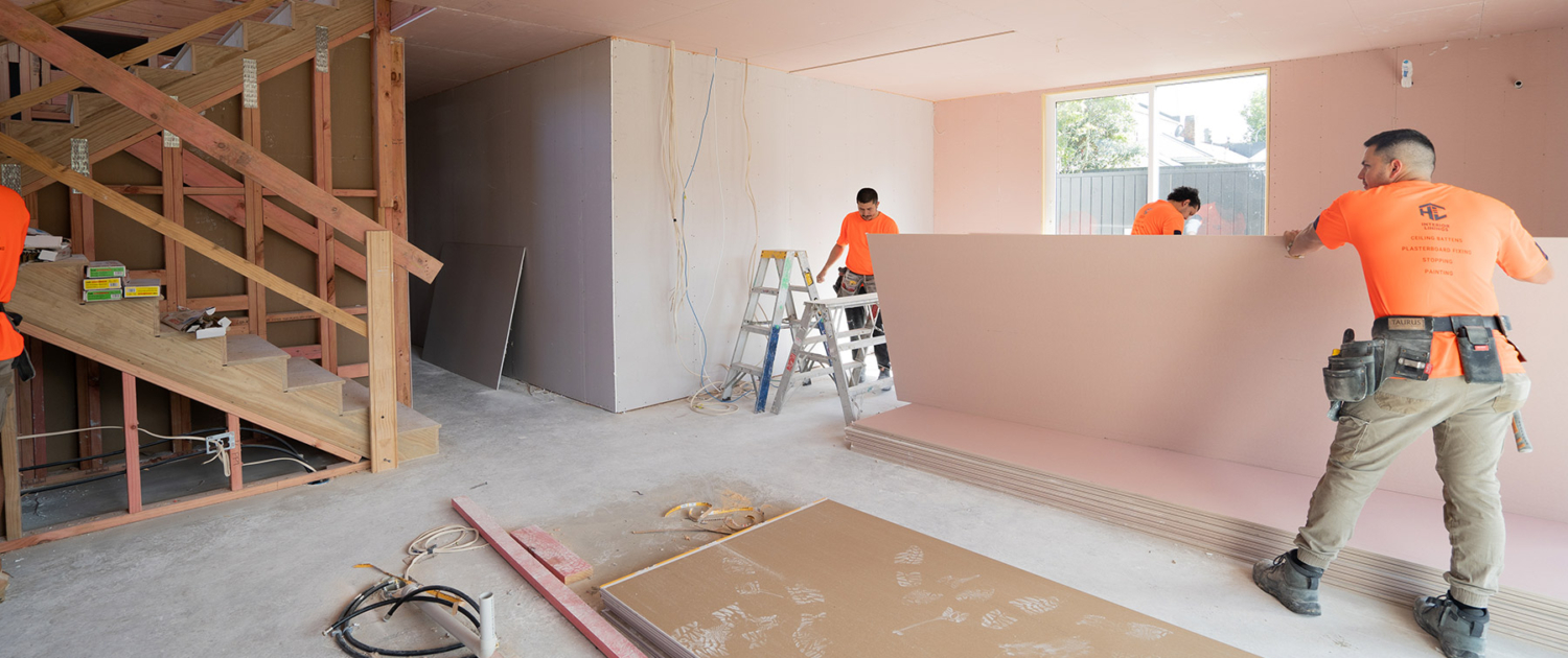 HL Interiors team putting up plasterboard on wall