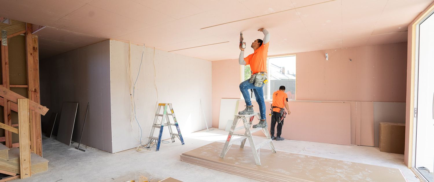 HL Interiors team putting up plasterboard on roof