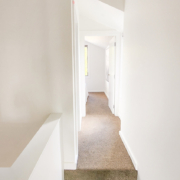 White hallway with carpet