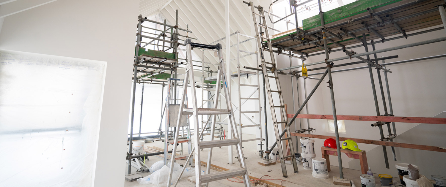 Room under construction with ladders and paint